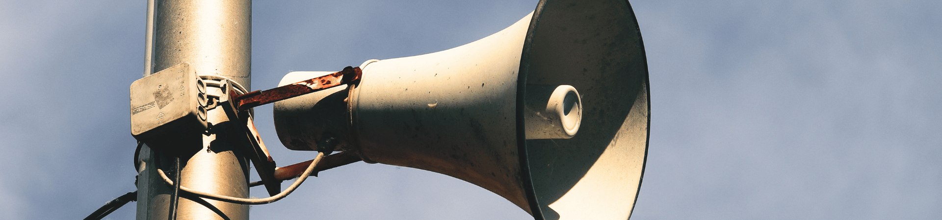 A photo of a loudspeaker on a pole