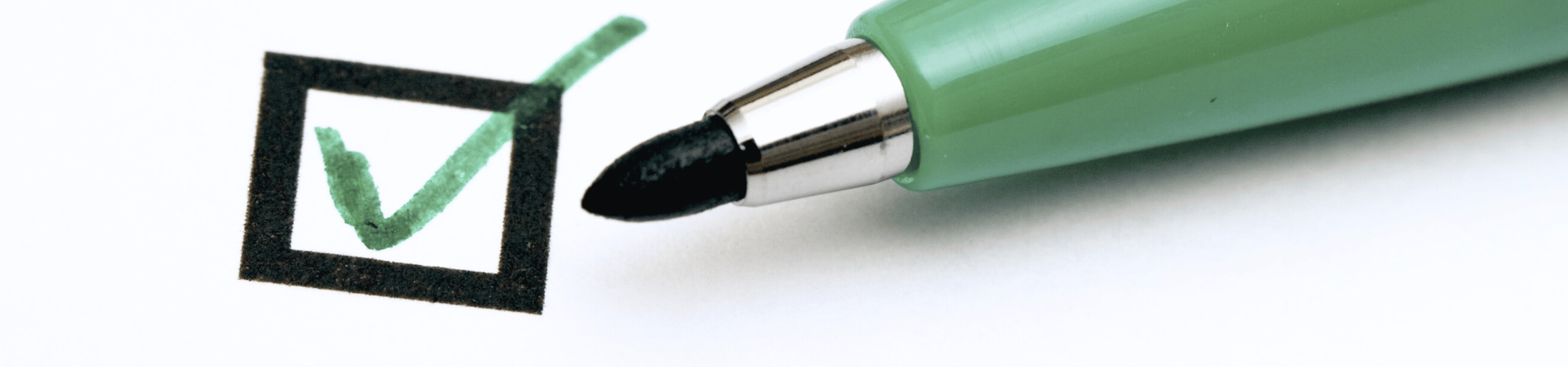 A green pen ticking off a check box