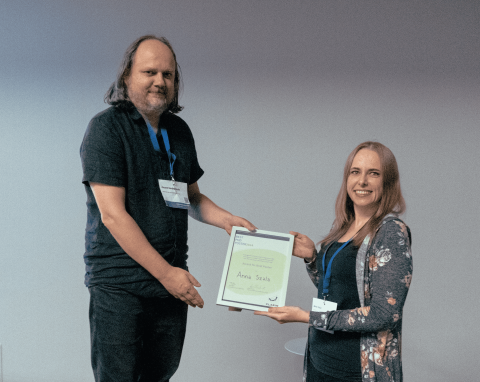 Picture of Anna Szala, being awarded for the best PhD poster.